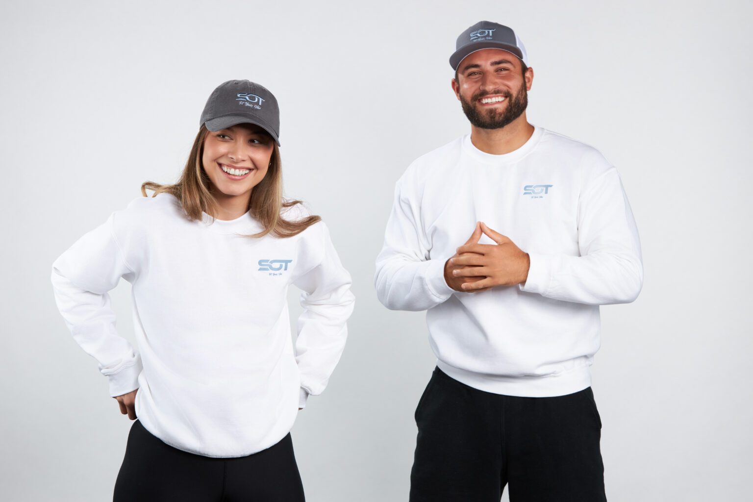 A man and woman wearing white shirts and hats.